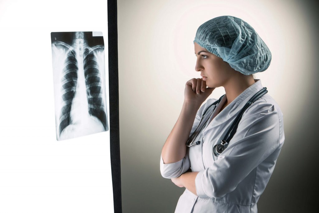 Image Of Attractive Woman Doctor Looking At X Ray Results